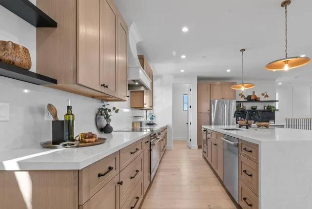 a kitchen with stainless steel appliances a refrigerator and cabinets