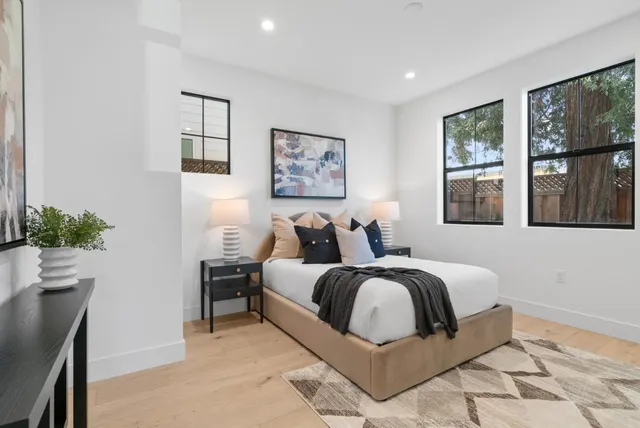 a view of hallway with a window and wooden floor