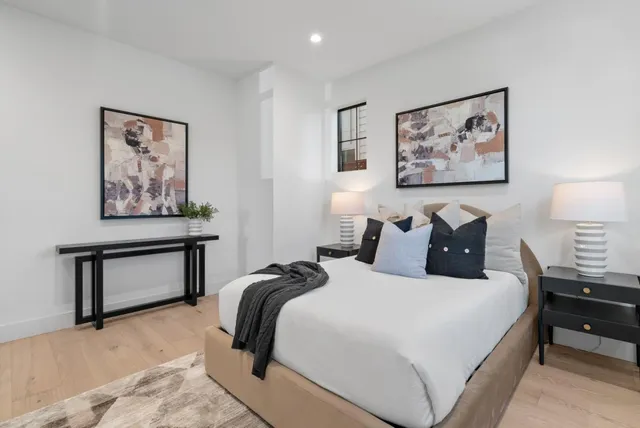 a bedroom with a large bed and a window