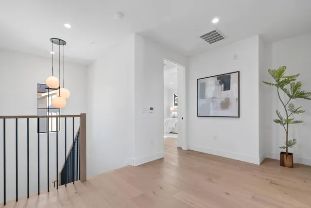 a bedroom with a bed mirror and window