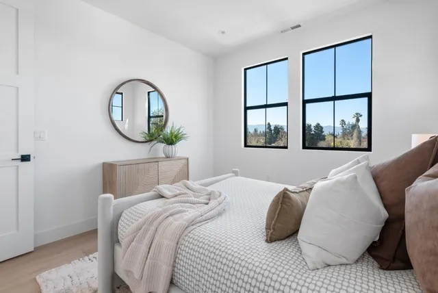 a bedroom with bed and a potted plant