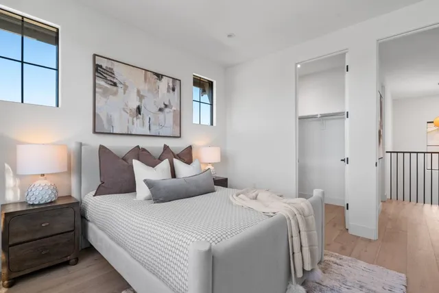 a bedroom with bed and painting on the wall