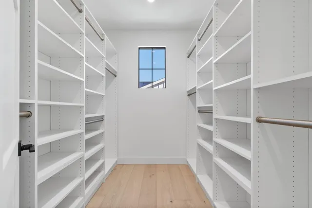 a bathroom with a white bath tub a mirror and a shower