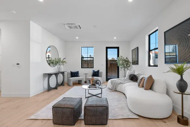 a living room with furniture and a potted plant