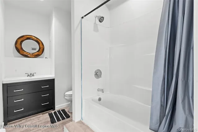 a bathroom with a bathtub a sink and a window