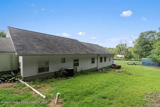 a backyard of a house with table and chairs