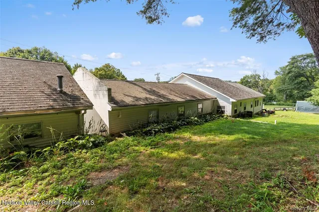 a aerial view of house with yard and outdoor seating