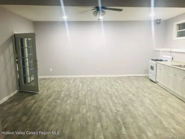 a view of an empty room with a kitchen