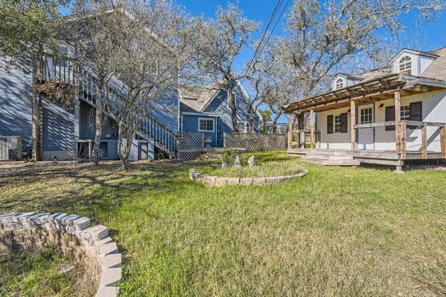 a view of a house with a yard patio and fire pit