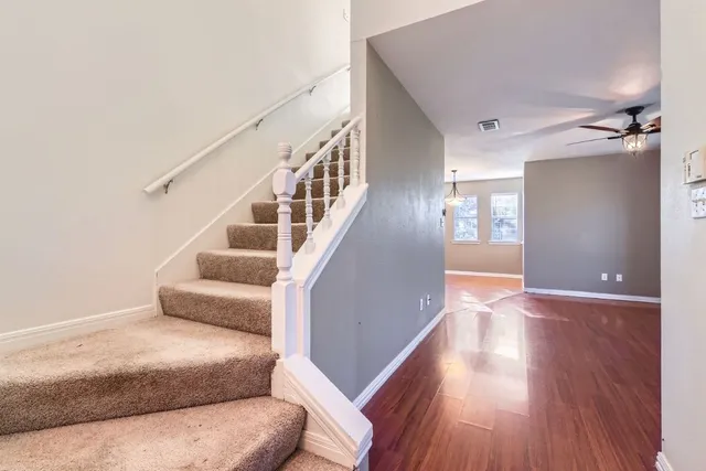 a living room with furniture and stairs