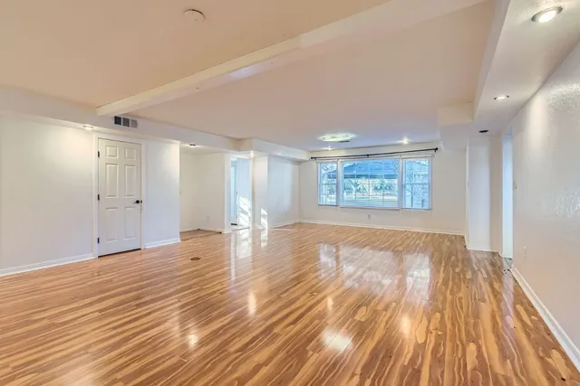 a view of an empty room and wooden floor