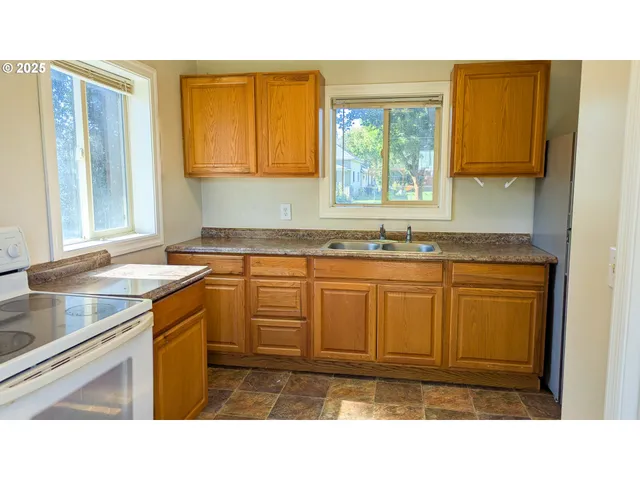 a kitchen with sink and cabinets