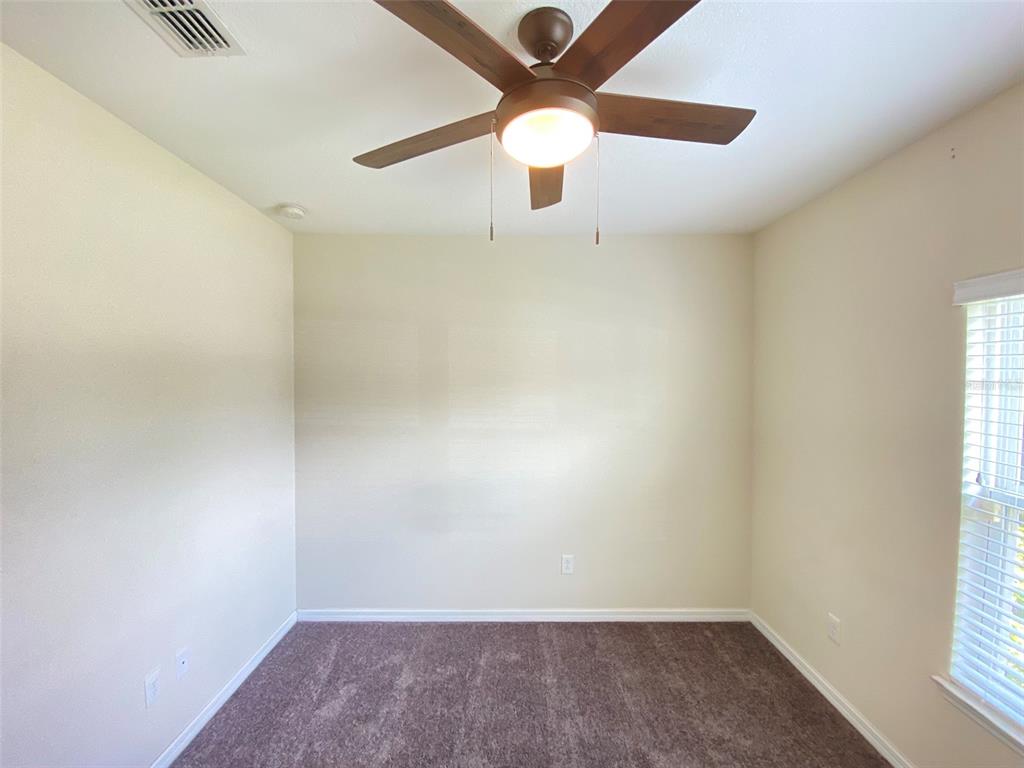 600 Northern Way, Unit 1001 Winter Springs, FL 32708 - Photo 10 of 37 an empty room with a window and a fan