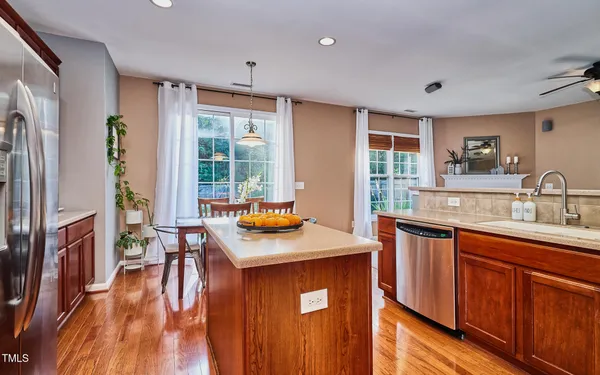 a kitchen with sink cabinets and wooden floor