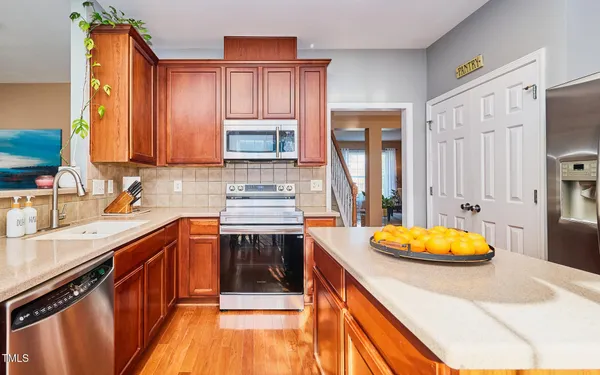 a kitchen with stainless steel appliances a stove sink and cabinets