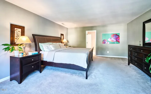 a bedroom with a bed and a dresser in it