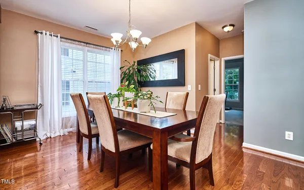 a view of a dining room with furniture and chandelier
