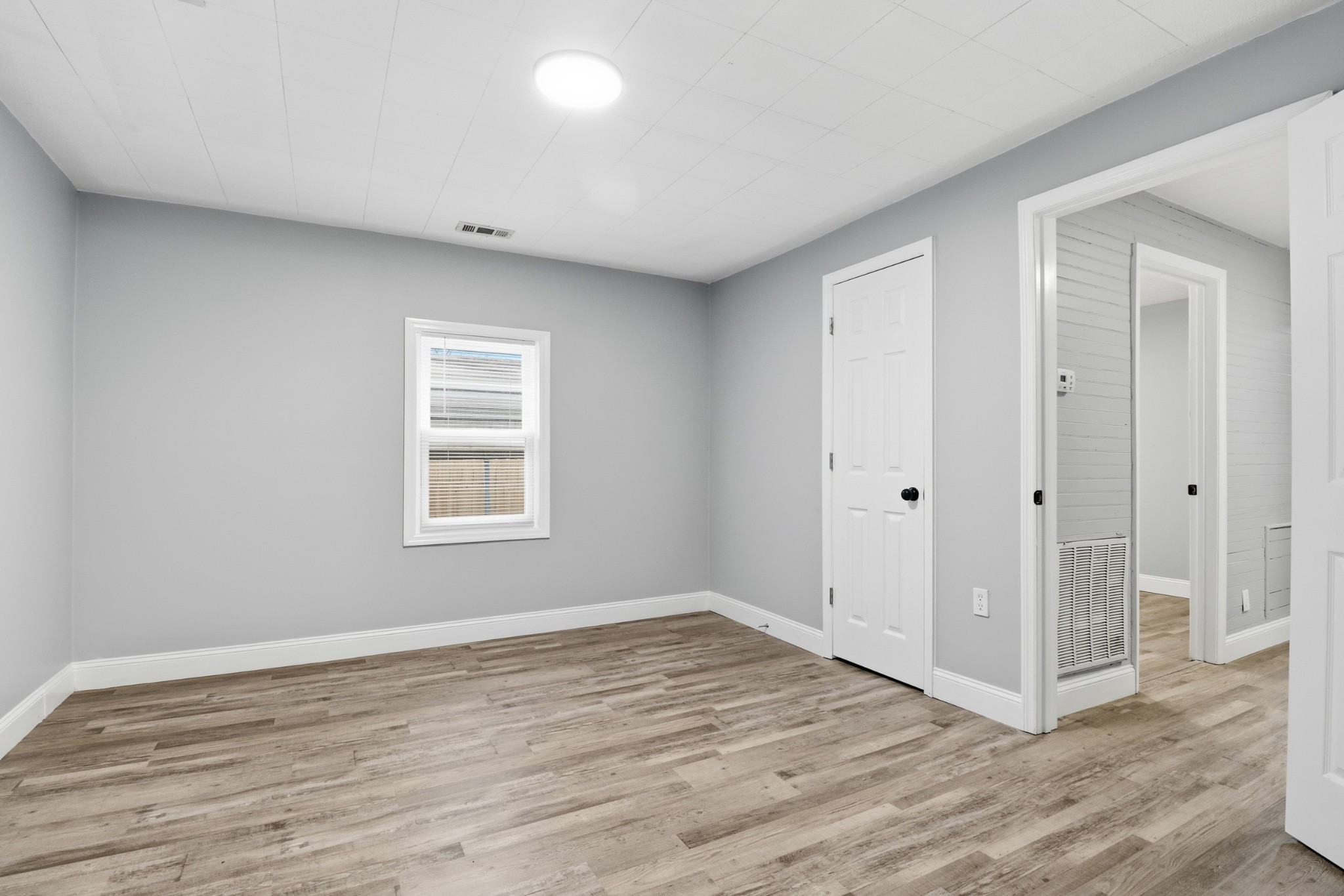 612 Maple Street Manchester, TN 37355 - Photo 8 of 20 a view of an empty room with wooden floor and a window