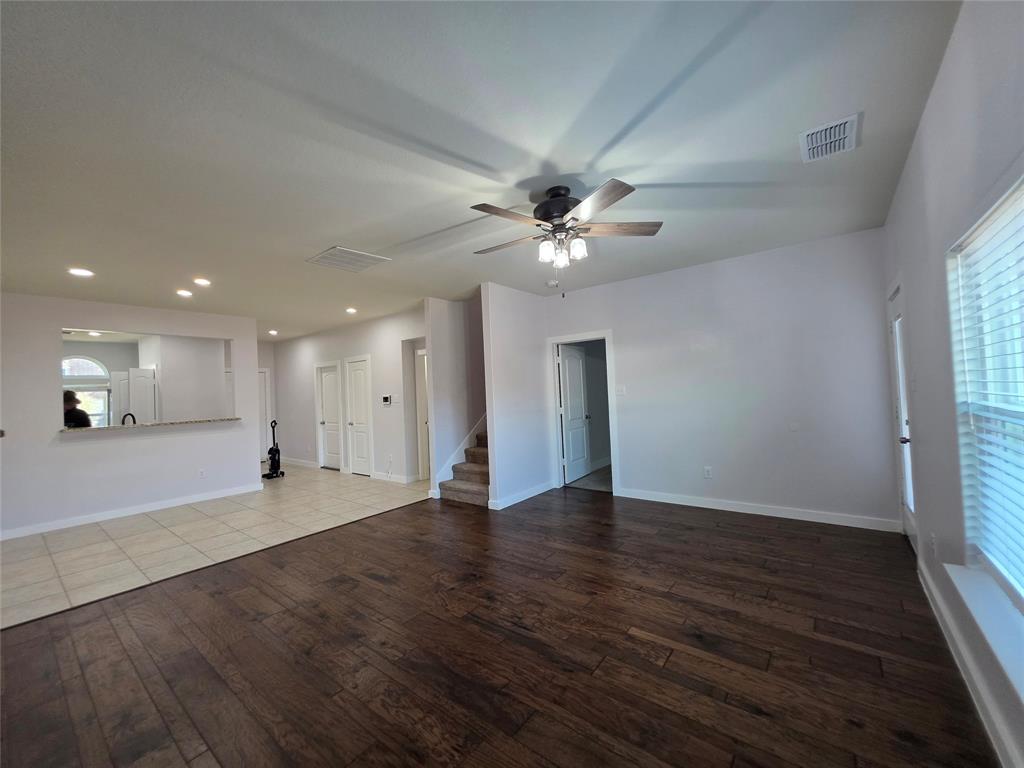 149 Ryan Street Anna, TX 75409 - Photo 6 of 38 wooden floor in an empty room with a window