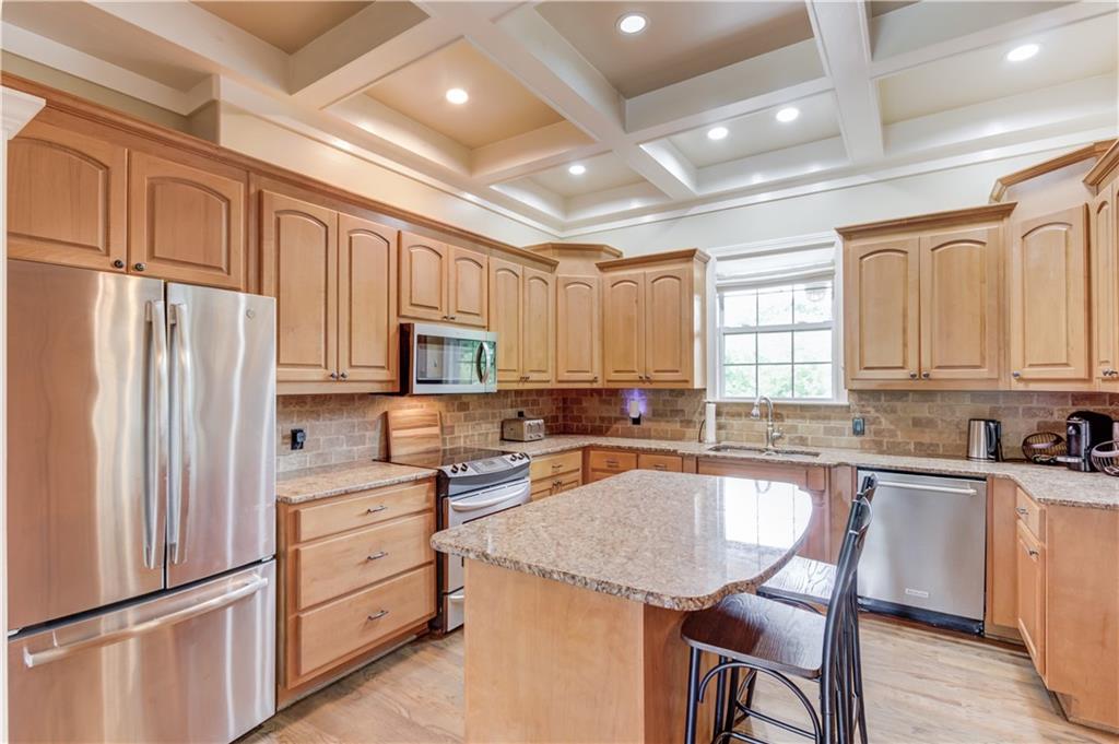 5667 Britt Whitmire Road Gainesville, GA 30506 - Photo 16 of 67 a kitchen with white cabinets and stainless steel appliances
