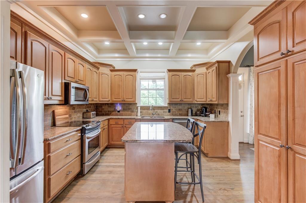 5667 Britt Whitmire Road Gainesville, GA 30506 - Photo 17 of 67 a kitchen with stainless steel appliances granite countertop a refrigerator a sink dishwasher a stove and a refrigerator with wooden floor