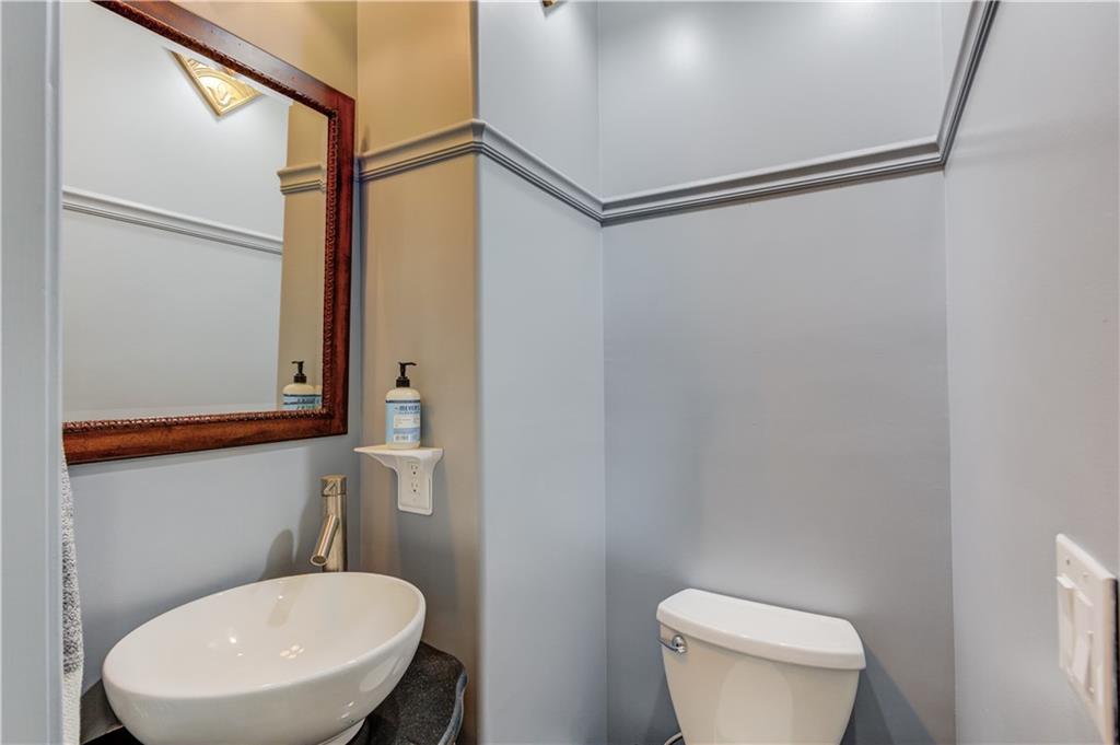 5667 Britt Whitmire Road Gainesville, GA 30506 - Photo 19 of 67 a bathroom with a toilet a sink and a mirror