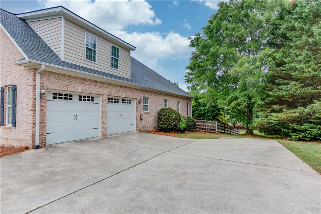 5667 Britt Whitmire Road Gainesville, GA 30506 - Photo 5 of 67 a front view of a house with a yard and garage