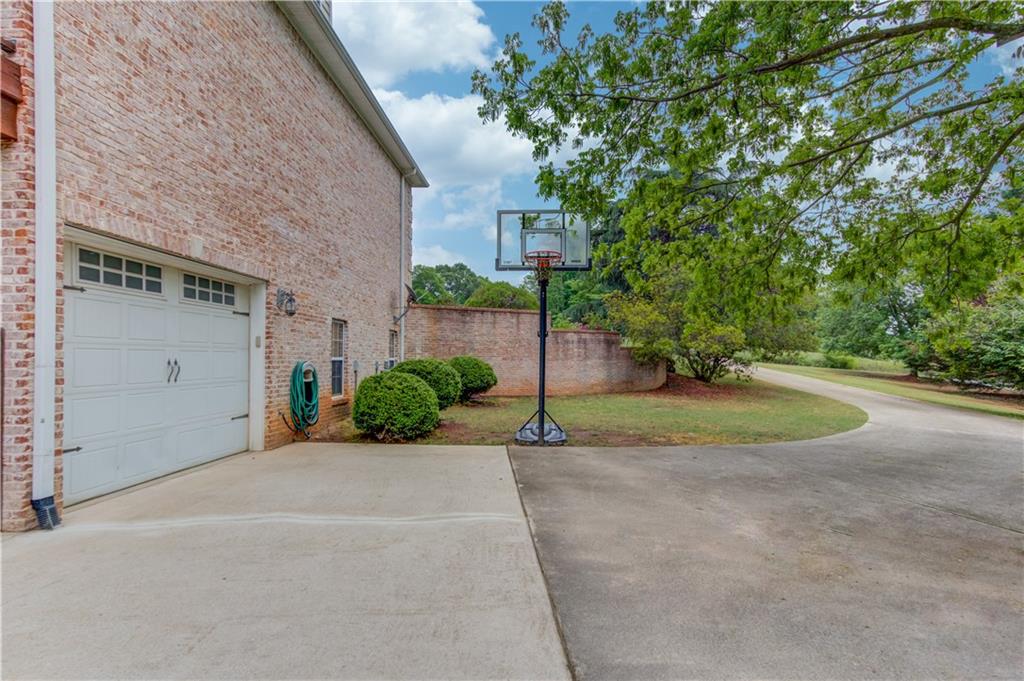 5667 Britt Whitmire Road Gainesville, GA 30506 - Photo 59 of 67 a view of a house with a yard and garage