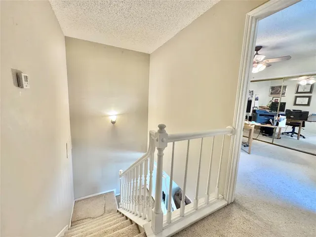 a bedroom with two beds and ceiling fan