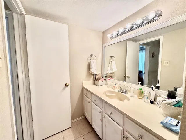 a bathroom with a double vanity sink mirror and toilet