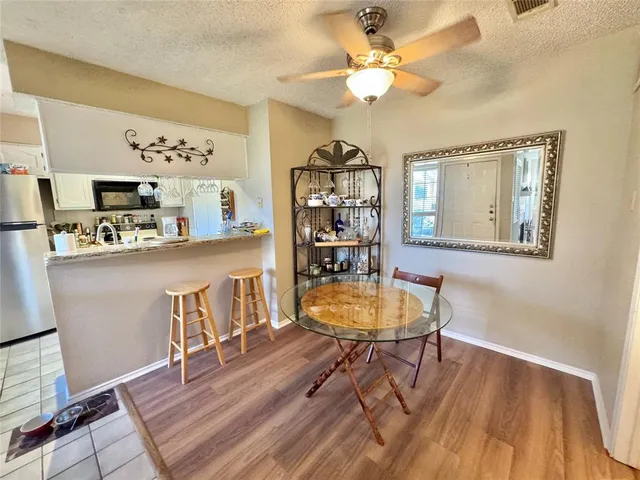 a dining room with wooden floor and a chandelier