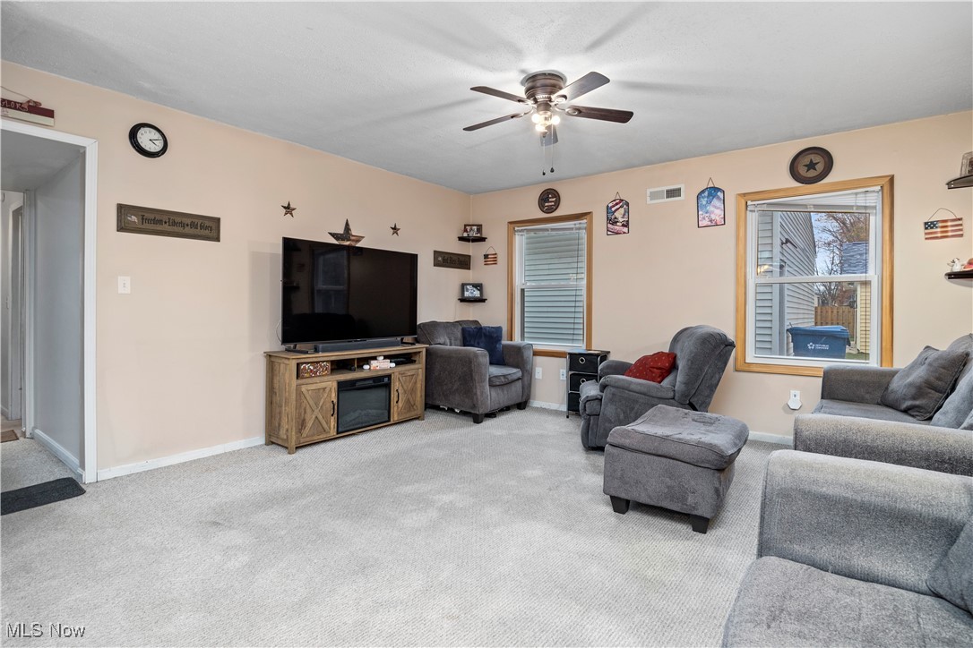 5569 Lear Nagle Road North Ridgeville, OH 44039 - Photo 15 of 41 Carpeted living room featuring ceiling fan