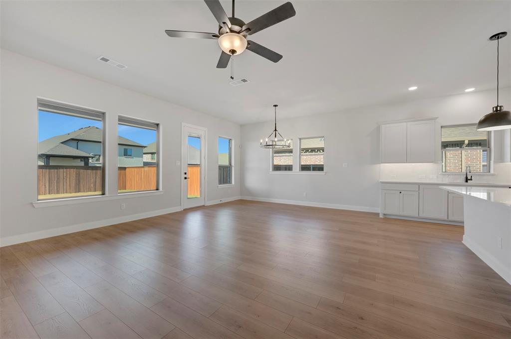 4022 Yellowstone Road Royse City, TX 75189 - Photo 12 of 20 a view of an empty room with window and wooden floor
