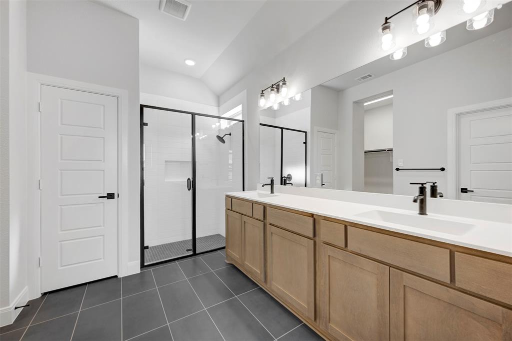 4022 Yellowstone Road Royse City, TX 75189 - Photo 16 of 20 a spacious bathroom with a double vanity sink mirror and shower