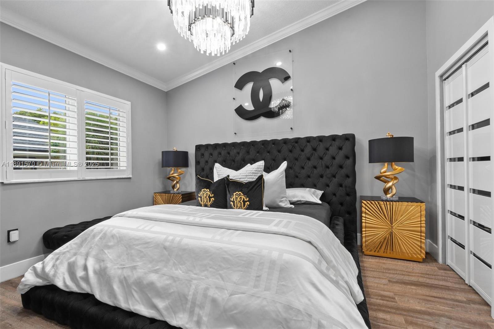 13160 Southwest 64th Terrace, Unit 1612 Miami, FL 33183 - Photo 13 of 32 a bedroom with a bed and wooden floor