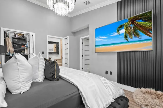 a bedroom with a bed and a painting on the wall