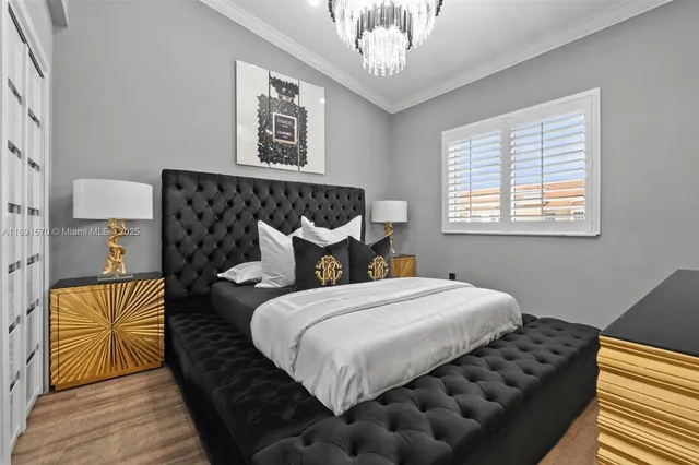 a bedroom with bed and wooden floor