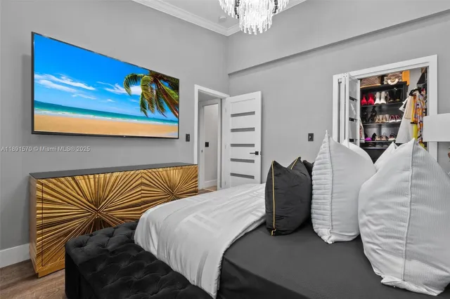 a bedroom with a bed and a painting on the wall