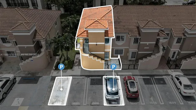 an aerial view of a house with swimming pool and barbeque grill