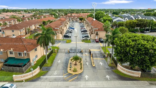 an aerial view of multiple houses with yard