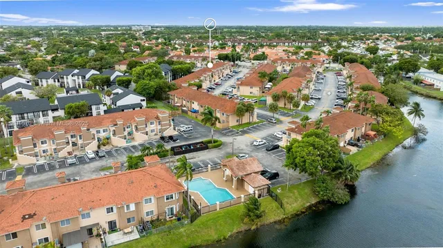 an aerial view of residential houses with outdoor space and river