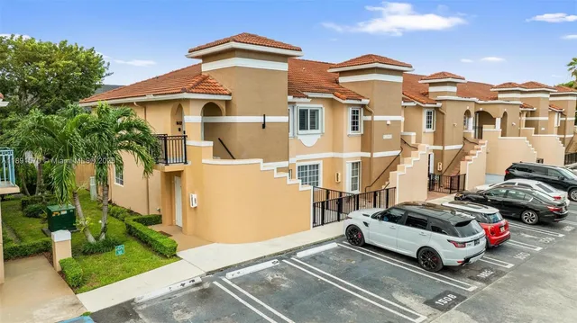 a car parked in front of a white house
