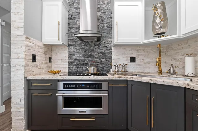 a kitchen with a sink stove and cabinets