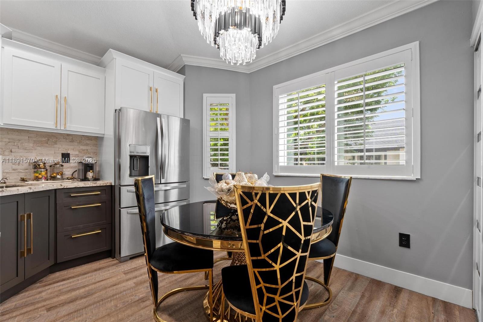 13160 Southwest 64th Terrace, Unit 1612 Miami, FL 33183 - Photo 7 of 32 a kitchen with stainless steel appliances a refrigerator a stove a sink and dishwasher with wooden floor