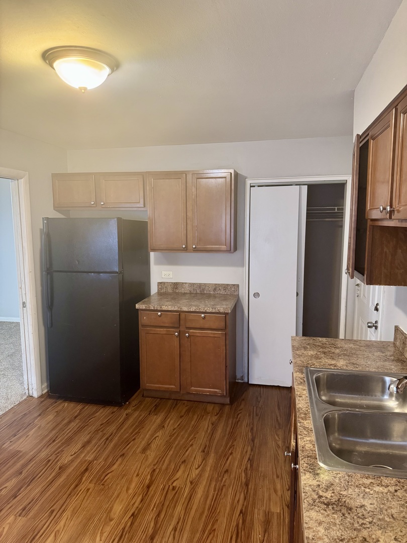 1212 East 151st Street Dolton, IL 60419 - Photo 15 of 24 a kitchen with a refrigerator sink and stove