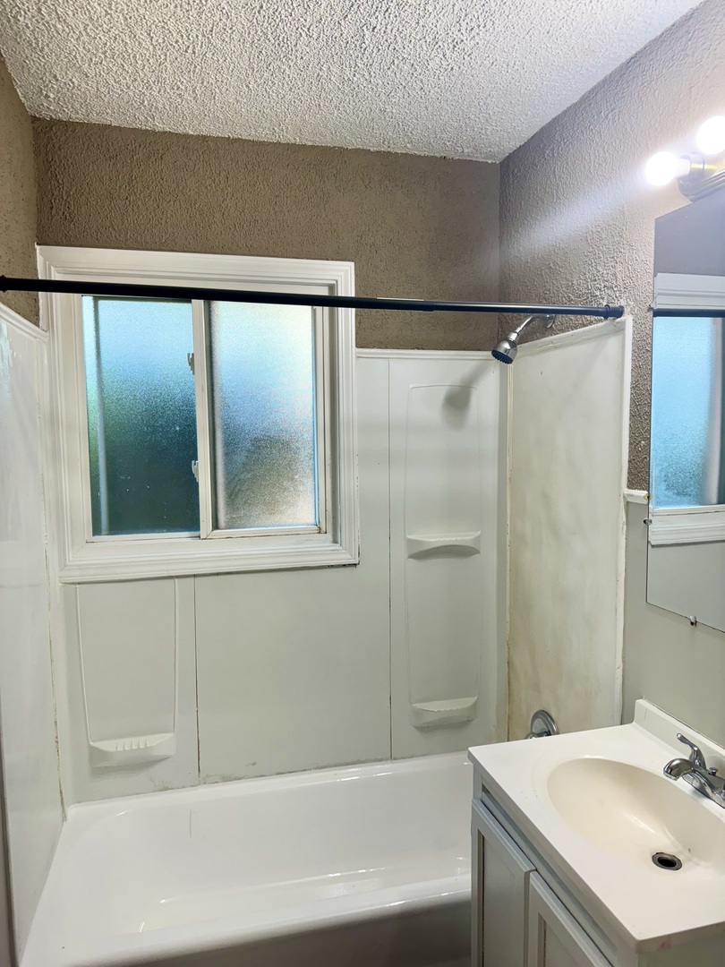 1212 East 151st Street Dolton, IL 60419 - Photo 19 of 24 a bathroom with a shower and a sink