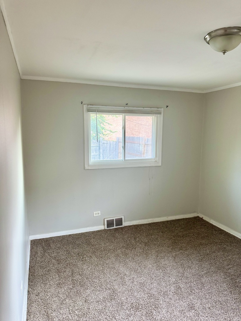 1212 East 151st Street Dolton, IL 60419 - Photo 7 of 24 an empty room with a window