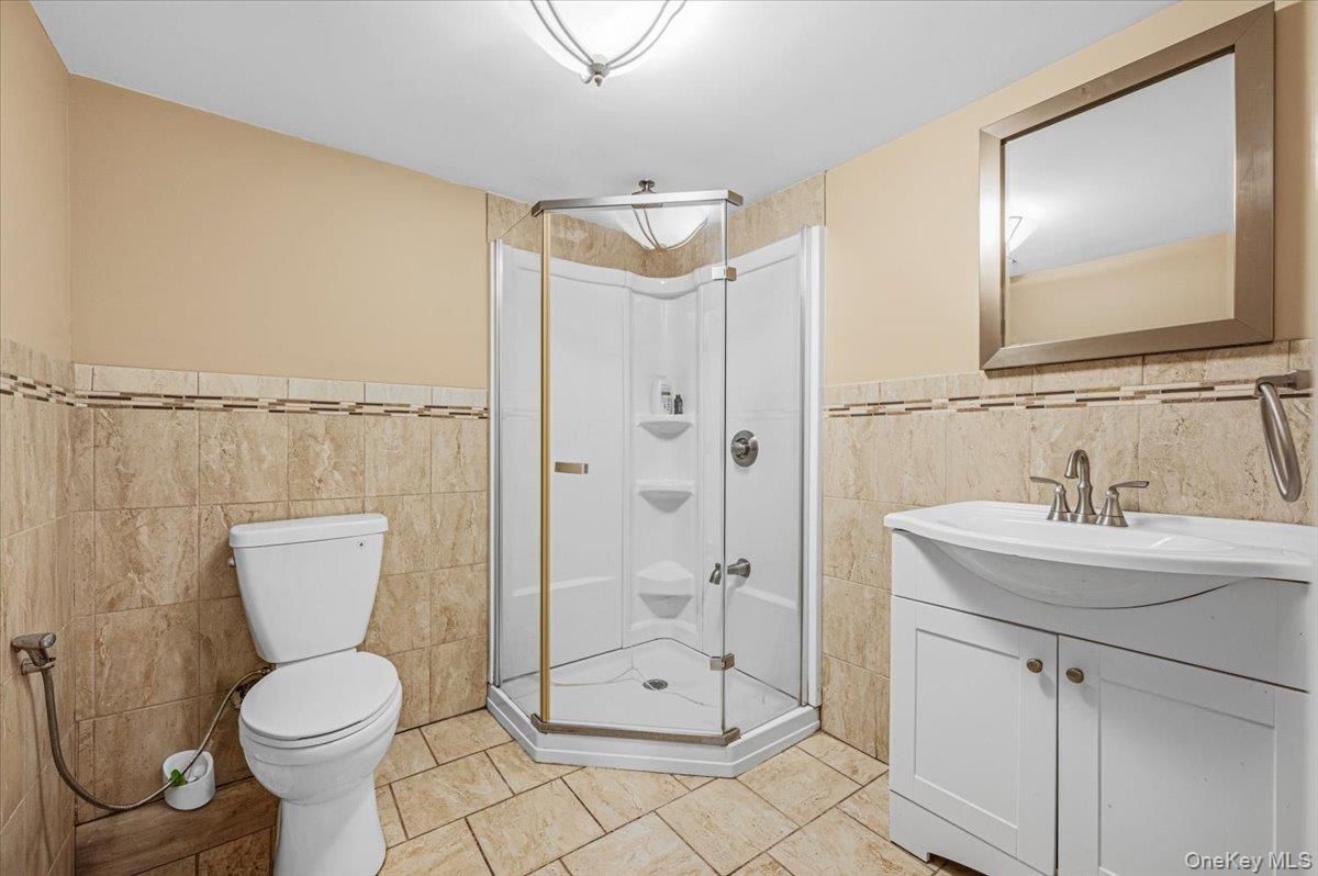 626 Caledonia Road Dix Hills, NY 11746 - Photo 15 of 49 a bathroom with a toilet sink and shower