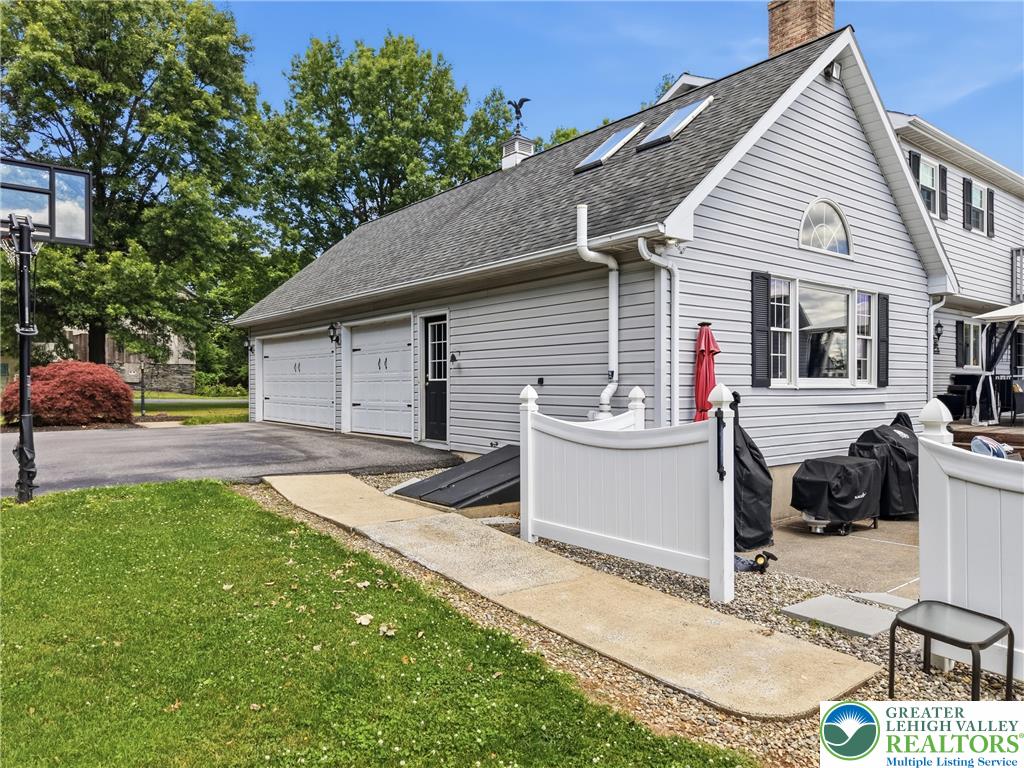 890 Lahr Road Nazareth, PA 18064 - Photo 57 of 71 A well-maintained residence features a spacious attached garage and a neatly landscaped yard.