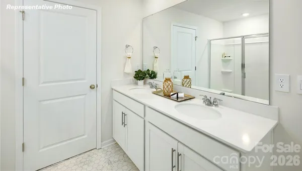 a bathroom with a granite countertop tub a sink and a large mirror